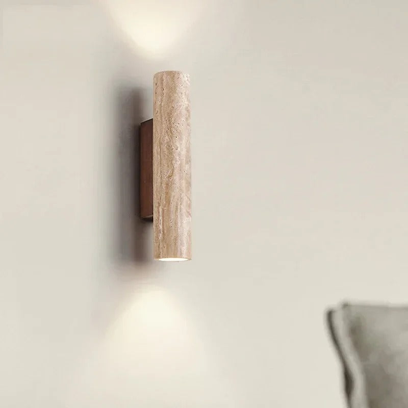 Stone cylinder wall light on a hallway wall