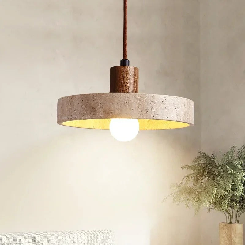 Natural stone disc pendant light with a walnut-tone top, switched on
