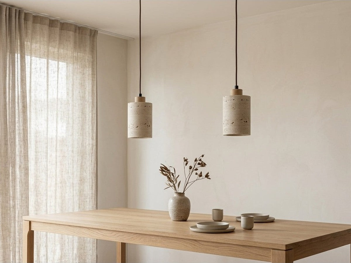Two stone pendant lights above a dining table.