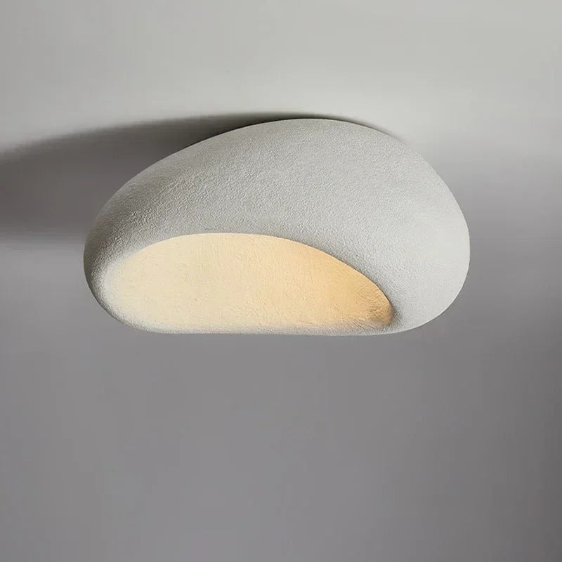 White wabi-sabi oval ceiling light, mounted flat, switched on