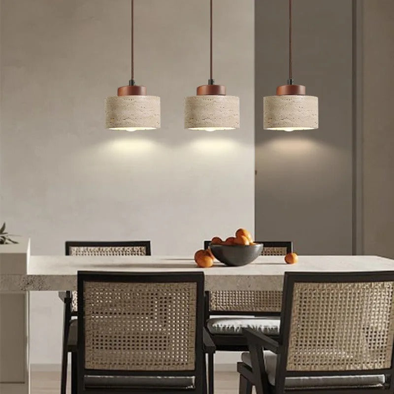 Yellow stone pendant lights above a dining table