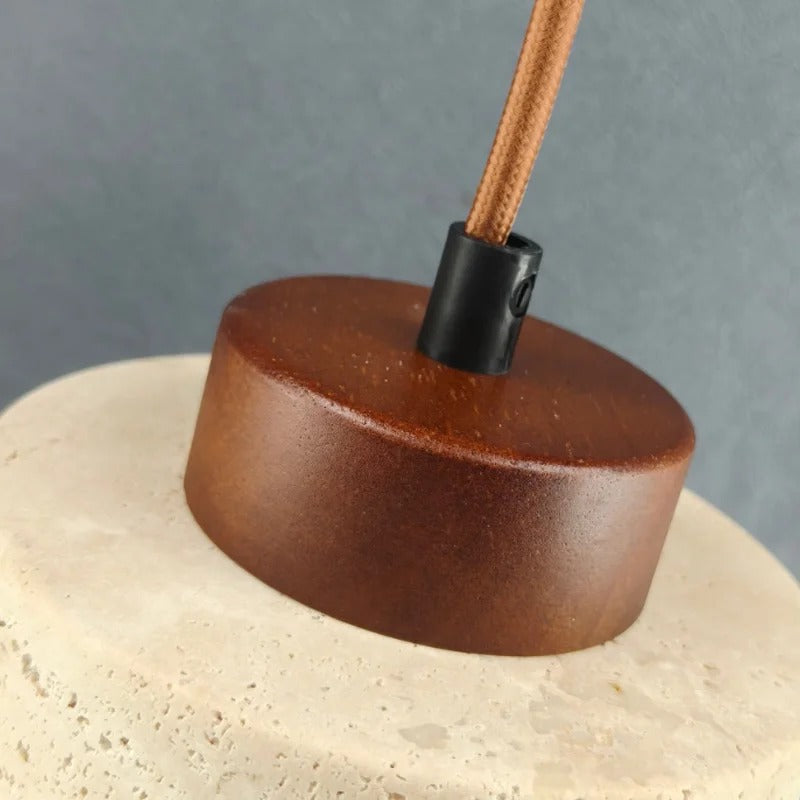 Close-up of the wood-tone top of the stone pendant light