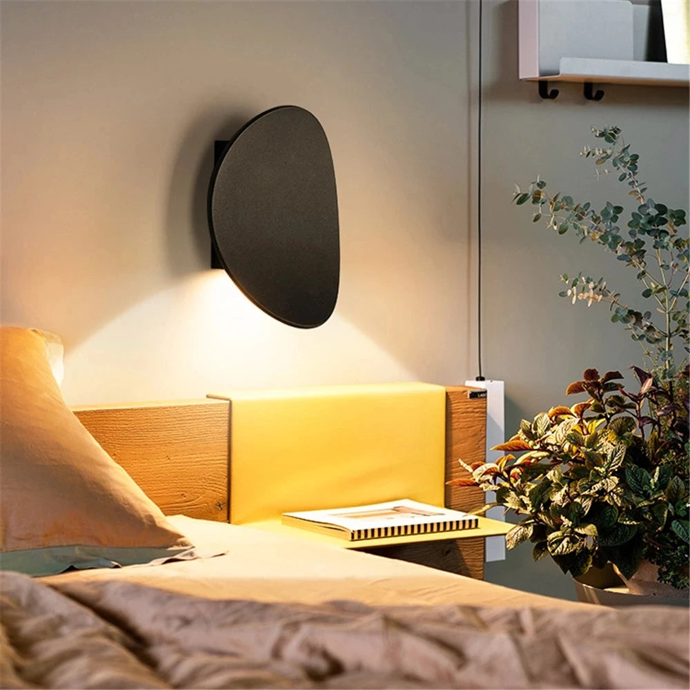 LED wall light casting a warm glow above and below the disc