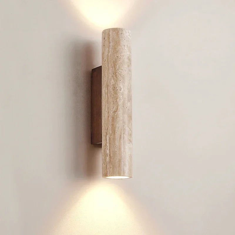 Natural stone cylinder wall light glowing up and down
