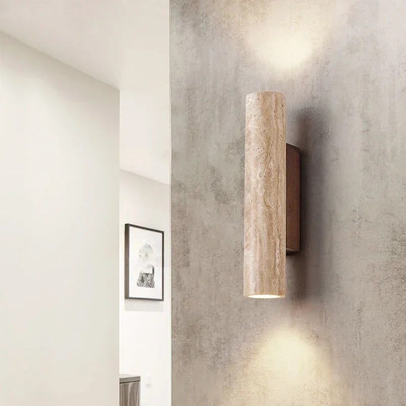 Stone cylinder wall light beside a doorway