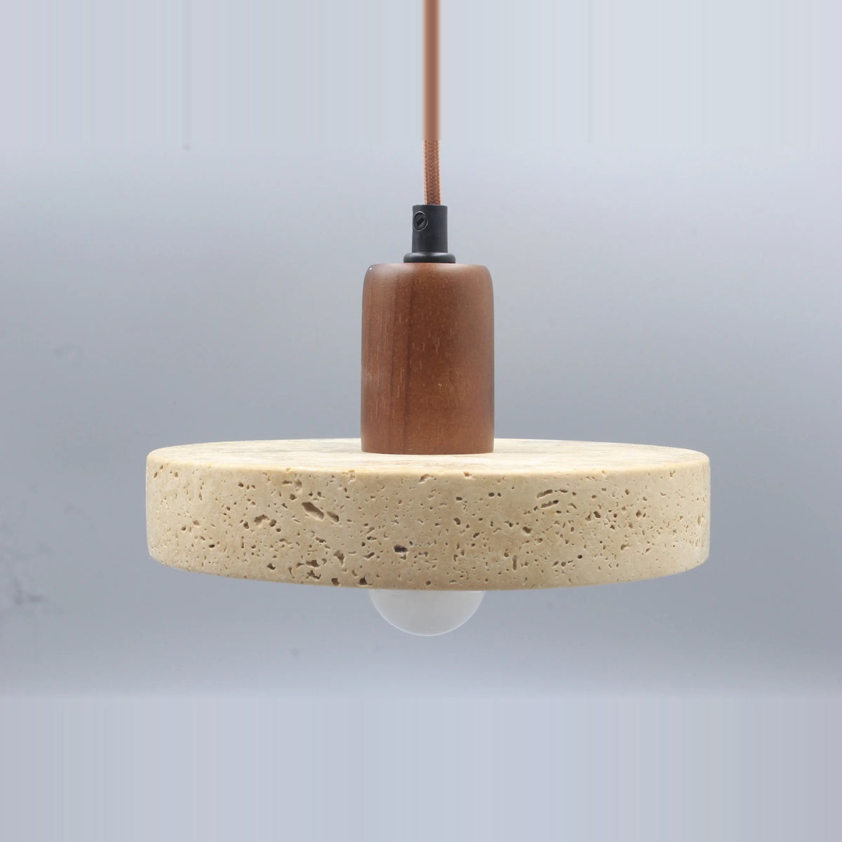 Stone disc pendant light with a walnut-tone top and the included bulb