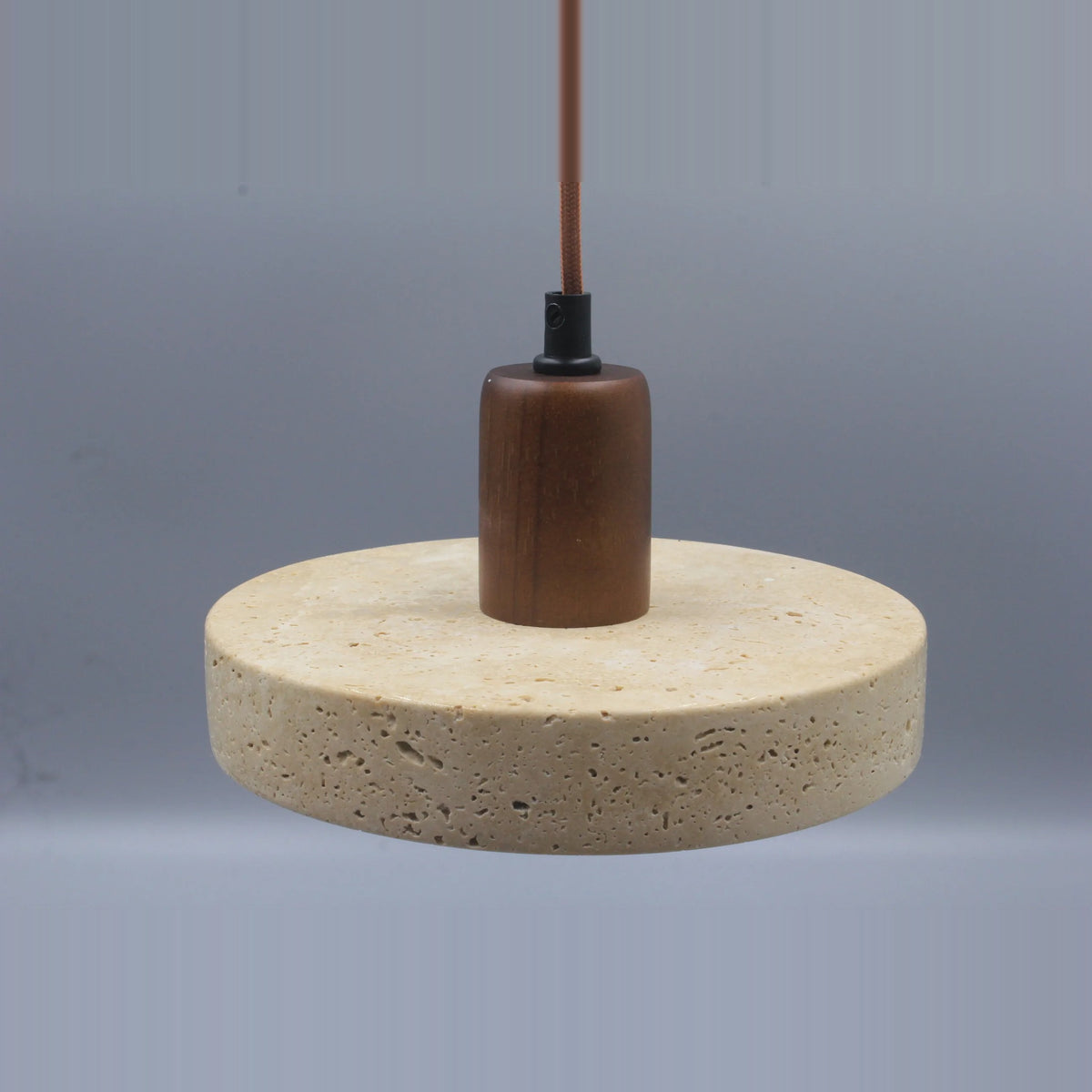 Stone disc pendant light with a walnut-tone top, front view