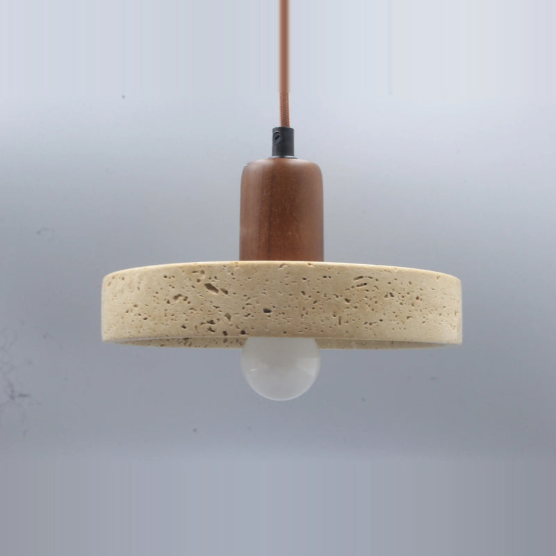 Side view of the stone disc pendant light with a walnut-tone top