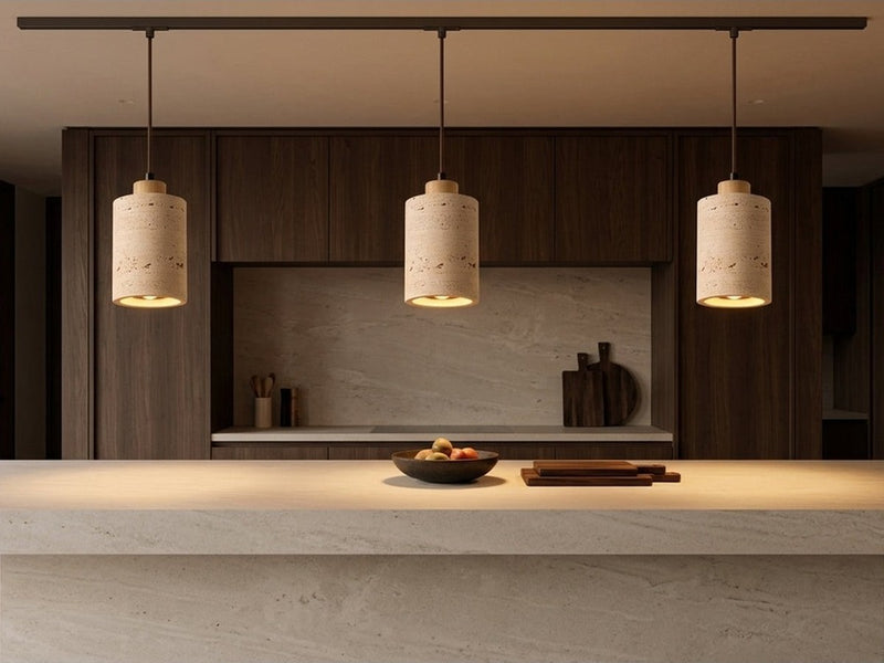 Three stone pendant lights over a kitchen island.