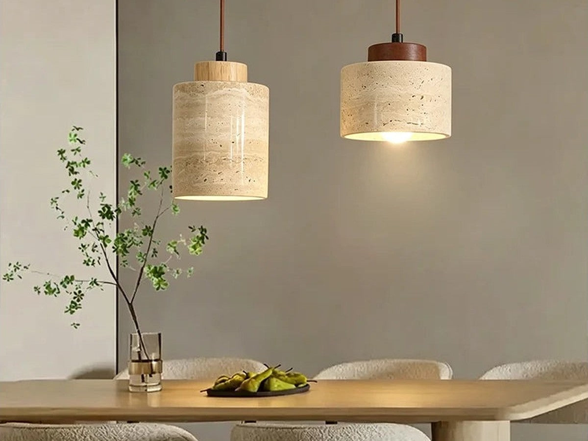 Two stone pendant lights above a dining table.