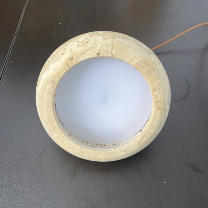 Underside of the travertine disc showing the built-in LED diffuser