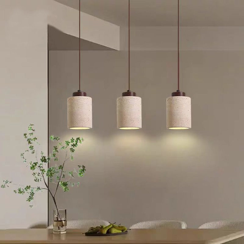 Three 16.5 cm travertine stone pendants over a table