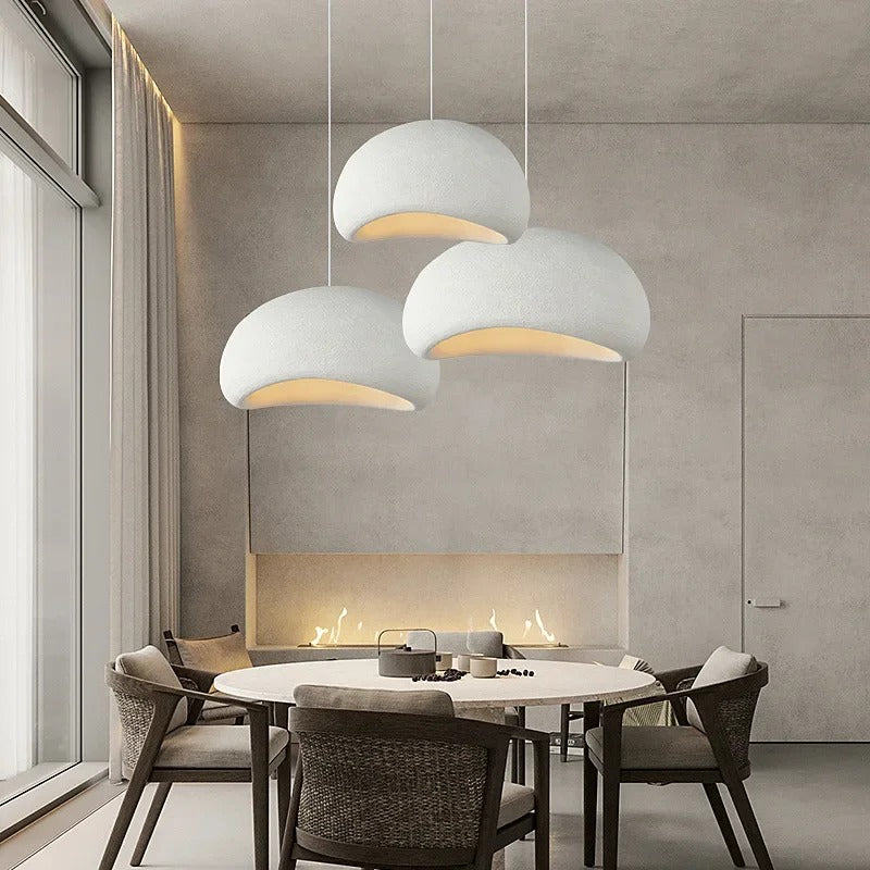White dome pendant lights over a dining setting