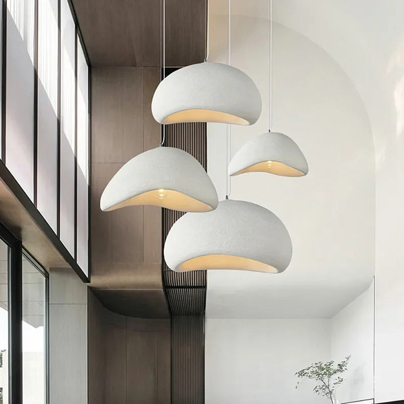 Group of white sculpted dome pendant lights at different heights