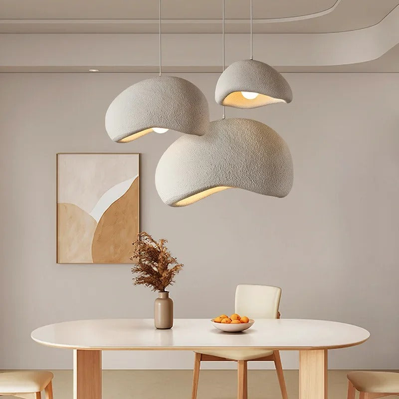 White wabi-sabi dome pendant lights over a dining table