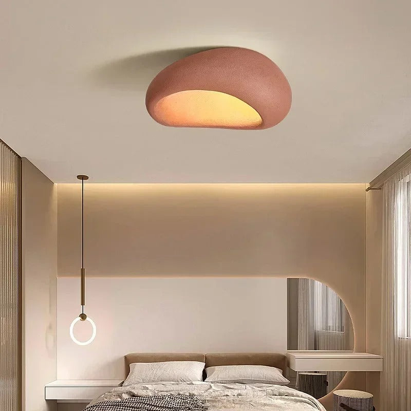 Red oval ceiling light in a bedroom