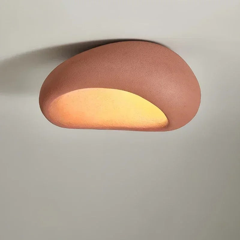 Red wabi-sabi oval ceiling light, mounted flat, switched on